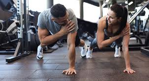 Image of man and woman doing Cardio Bicester to tone their arms. 